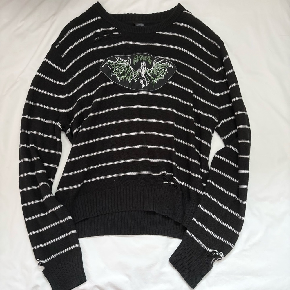 SWIXXZ by maggie lindemann black bat graphic striped distressed knit sweater